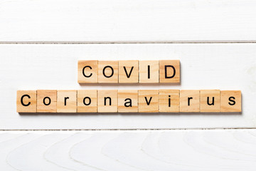 Covid word written on wood block. Covid text on wooden table for your desing, Wuhan Coronavirus, 2019-nCoV. concept top view