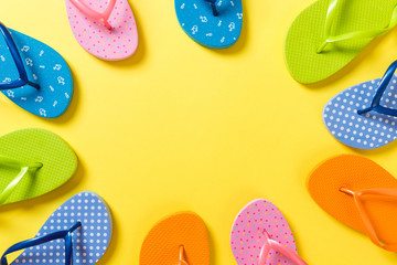 a lot of flip flop colored sandals, summer vacation on colored background, copy space top view
