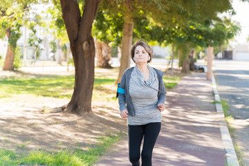 Fototapeta premium Senior Woman Jogging On Sunny Day