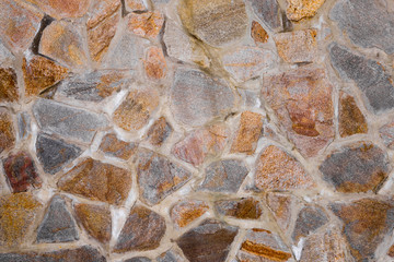 Texture of the wall made of granite stones. Construction, decoration.