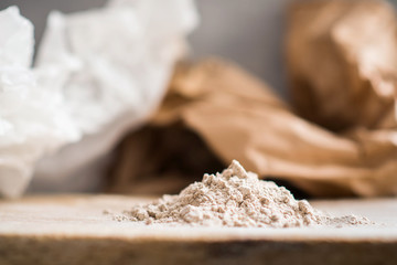 Teff flour on a wooden surface with a rustic background