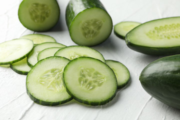 Cucumbers and slices on white background, close up