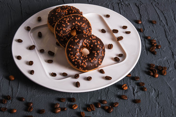 chocolate donuts lie on a plate