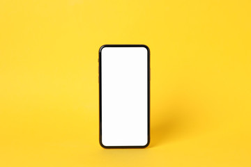 Phone with empty on yellow background, space for text