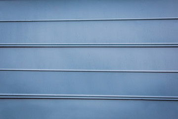 blue metal panel wall of an outdoor building structure like a shed