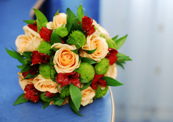 Bright wedding bouquet for the bride with orange roses and red Alstroemeria