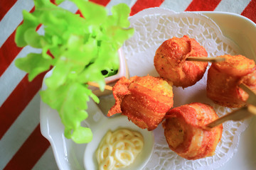 Appetizer croquette wrap bacon skewer. Cocktail style western food.