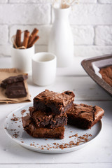 Brownie chocolate cake served on white table