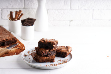 Brownie chocolate cake served on white table