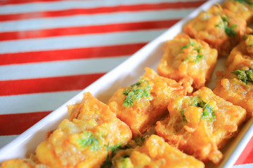 Popular thai food deep fried bread topped with minced shrimp and egg.