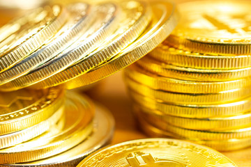 Rows and stacks of cryptocurrency coins on wooden table. Horizontal orientation close up view blurred background for finance and business concept.