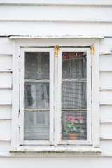 SKUDENESHAVN, NORWAY - 2018 JULY 05. White old charming window with photo of a woman inside the window,