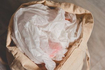 A rag bag filled with used plastic bags. Close-up from above. Grunge style. Copy space