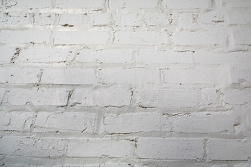 Rough textured white painted brick wall