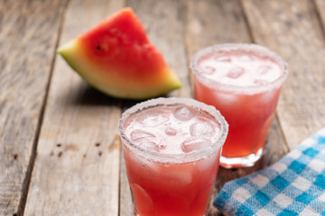 Mexican watermelon margarita cocktail on wooden background