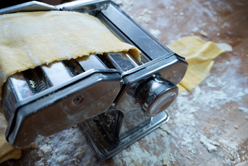 Fresh pasta machine stretching the dough