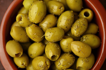 Green olives in clay bowl, Spanish tapas