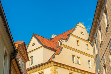 Obraz premium View of the top of old buildings with red roof and blue sky at Prague city Czech republic.