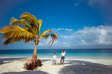 Dream vacation. Happy family mother and son on the ocean under a palm tree. Zanzibar island.