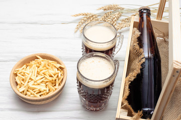 Frothy beer in the drinking glass top view on the white background.