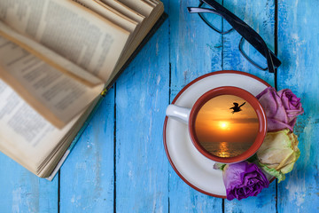 Dream of relaxation, in a mug of tea a reflection of sea sunset