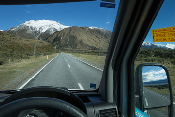 On the road. Driving on the leftside of the road in a campervan at the highway. Mount Cook. New Zealand.  Southern Alps.