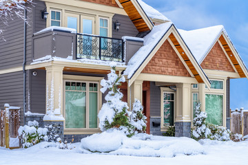 A perfect neighborhood. Fragment of a nice house in suburb at snow winter in the north America.