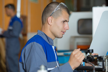 young engineer is control lever machine