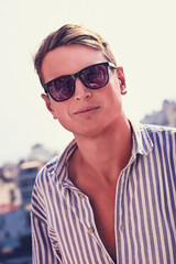 young man fashion photoshoot at the beach sunny day