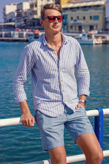 young man fashion photoshoot at the beach sunny day