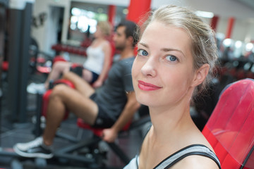 portrait of woman relaxing on reformer in gym