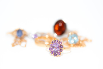 Collection of jewelry with beautiful golden ring with purple stone isolated on white background
