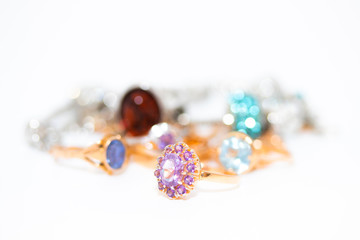 Collection of jewelry with beautiful golden ring with purple stone isolated on white background