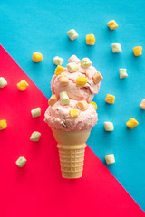 ice cream on a cone in front of red and blue background - 323047547