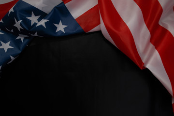 Fototapeta na wymiar Close up of waving national usa american flag on black background with copy space.