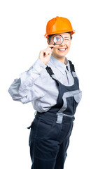 girl construction engineer examines something in a magnifying glass. Isolated