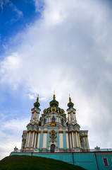 Travel to Ukraine - building of St Andrew`s Church in Kyiv city under cloudy sky