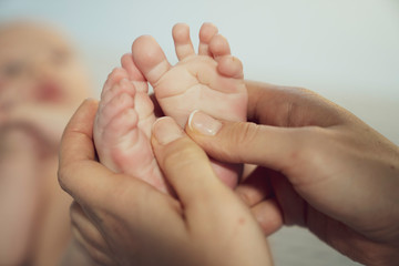 newborn baby feet on female hands