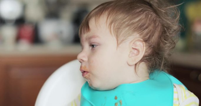 Infant boy eats meat