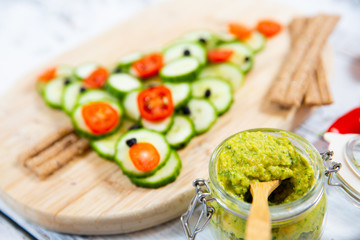 Vegetable salad with tomatoes, cucumber and olives. Christmas tree shape.