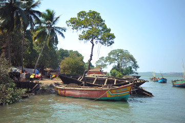 Naklejka na ściany i meble fishing village in india, view from the water, fishing boats