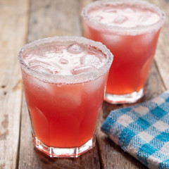 Mexican watermelon margarita cocktail on wooden background