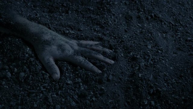 Arm Sticking Out Of The Ground In The Dark