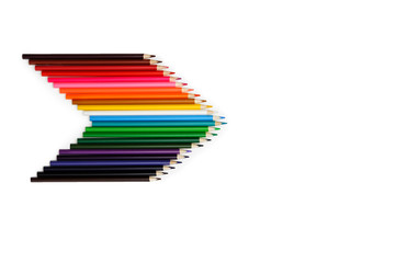 set of colored pencils arranged in the shape of an arrow with the right pencil on a white background