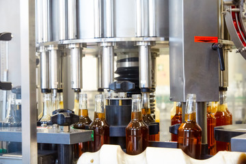 Distillery factory. Strong alcoholic tinctures are bottled in the workshop on the conveyor
