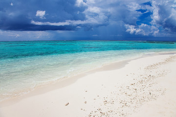 Fototapeta premium Turquoise blue sea water shore and cloudy sky