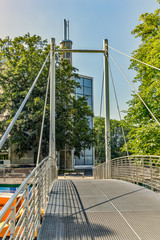 Bern, Switzerland - July 30, 2019: A wide metal mounted pedestrian bridge in the Lorrainestrasse street of the capital. Vertical. View at sunny summer day