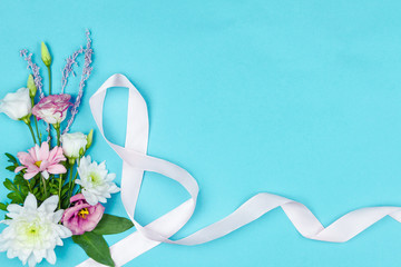 Inscription number 8 made of ribbon, bouquet of pink and white flowers are on blue background. Greeting card template, invitation for celebration, party, event. Happy international women day concept.
