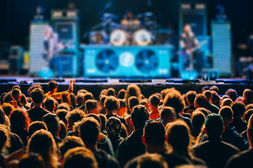 Concert and music festival background with hands raised and party people. 