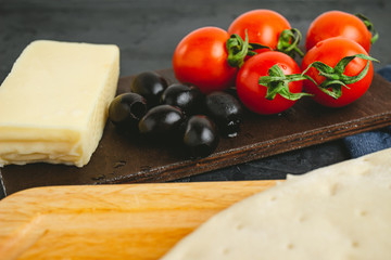 Black olives, cherry tomatoes, mozzarella cheese, dough, ingredients to pizza cooking